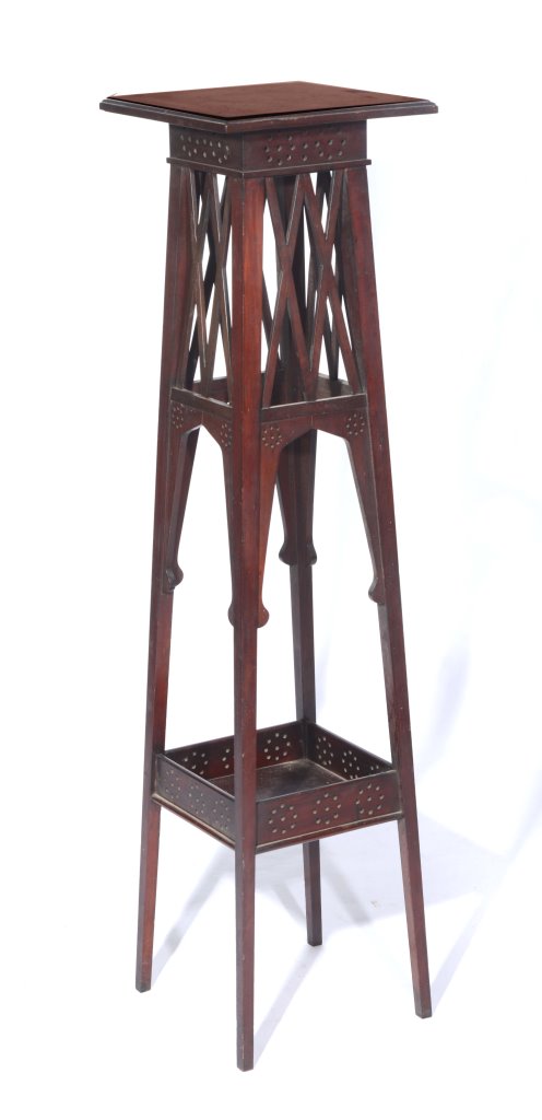 AN ARTS AND CRAFTS MAHOGANY TALL PLANT STAND with open fretwork decoration, 122cm high