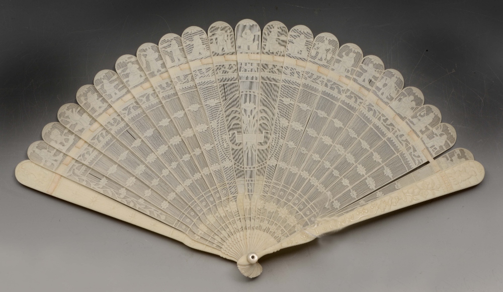A CHINESE CANTON IVORY BRISE FAN, the guards decorated with Chinese trades, and with a central