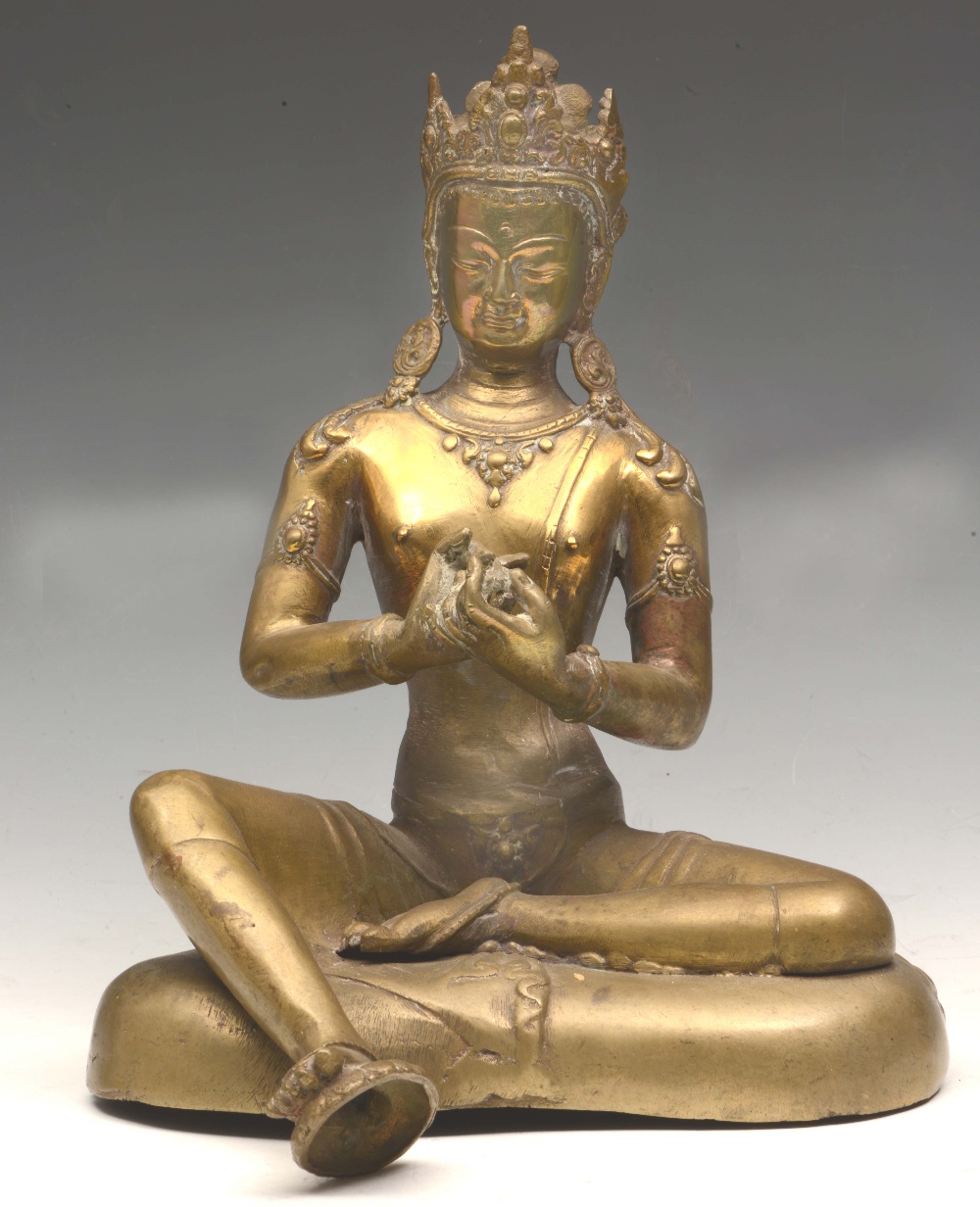 A SINO-TIBETAN GILT BRONZE MODEL OF AMITAYUS seated on a cushion base, both hands in dharmachakra