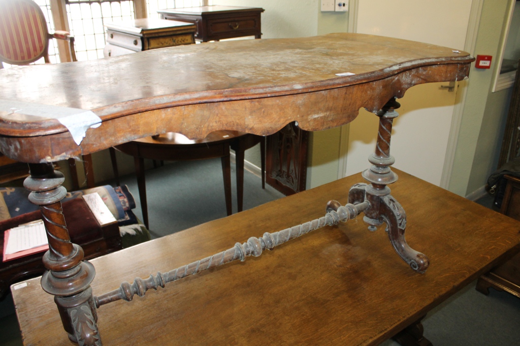 A VICTORIAN WALNUT CENTRE TABLE having a shaped top with stretcher, 46" across