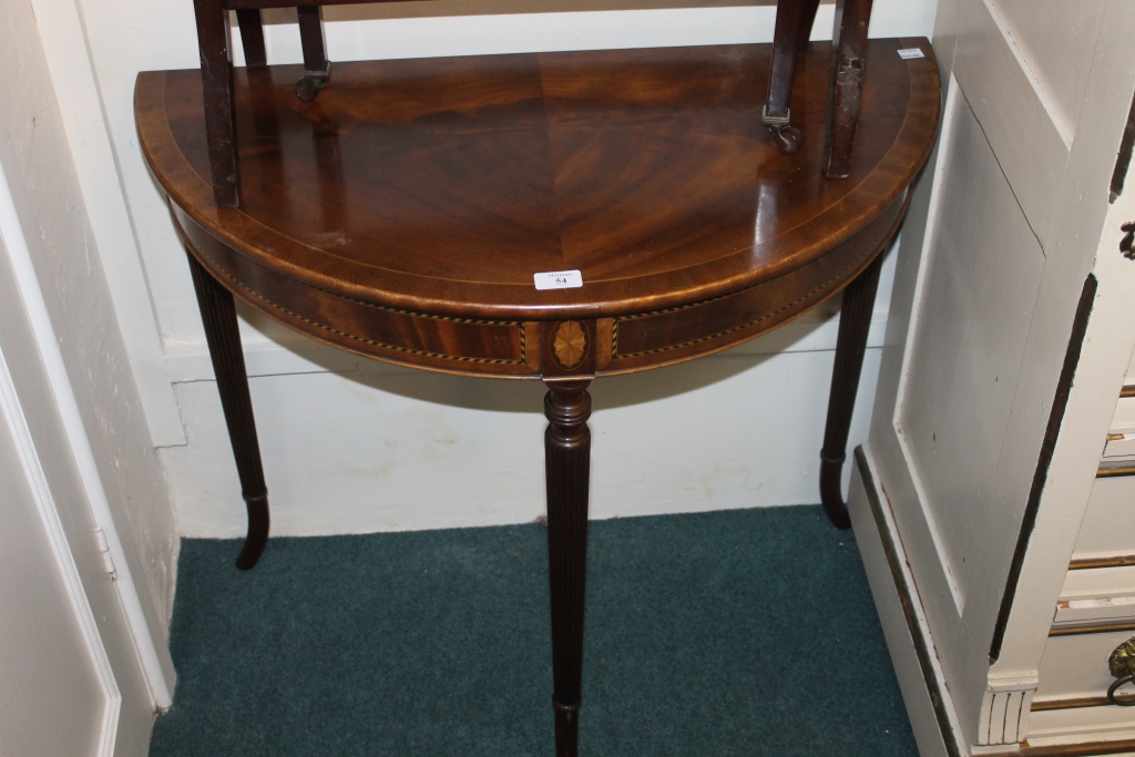 A REPRODUCTION DEMI-LUNE SIDE TABLE on fluted supports, 31"