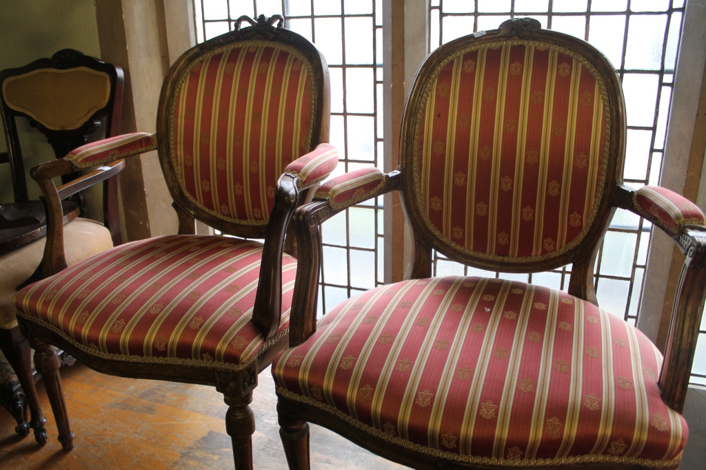 A PAIR OF FRENCH BEECHWOOD FRAMED FAUTEILS, each with red striped upholstery on fluted supports (