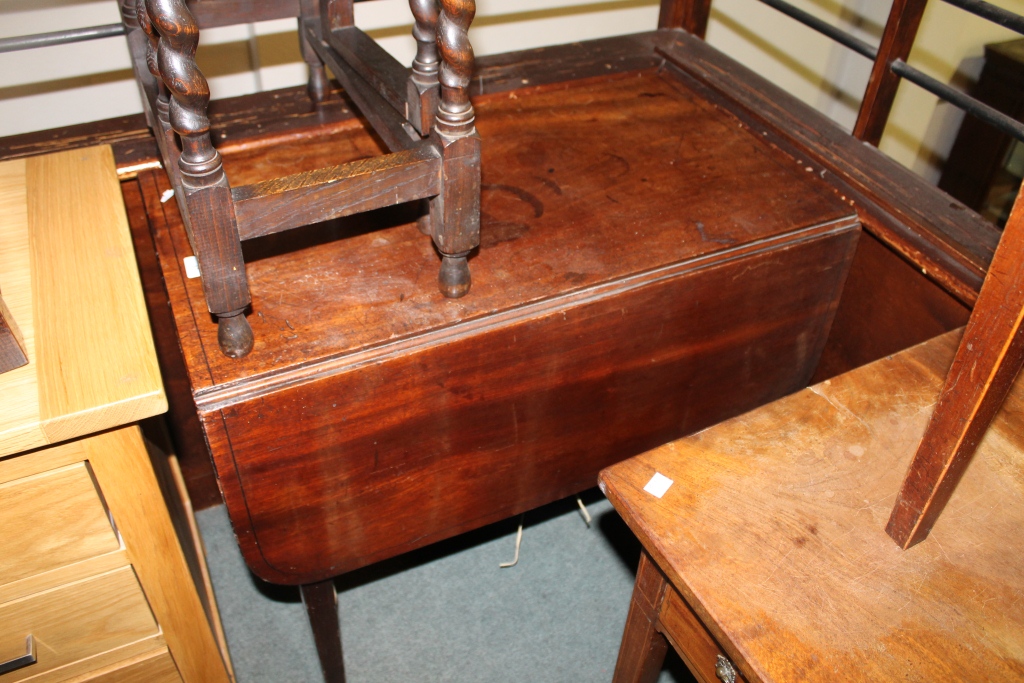 A GEORGIAN MAHOGANY PEMBROKE TABLE fitted with drop flaps and square taper supports with deep false