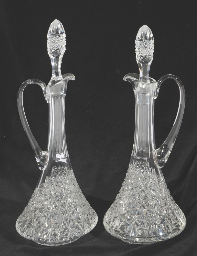 A PAIR OF HEAVY CUT GLASS DECANTERS, each with star and hobnail decoration, 19" high