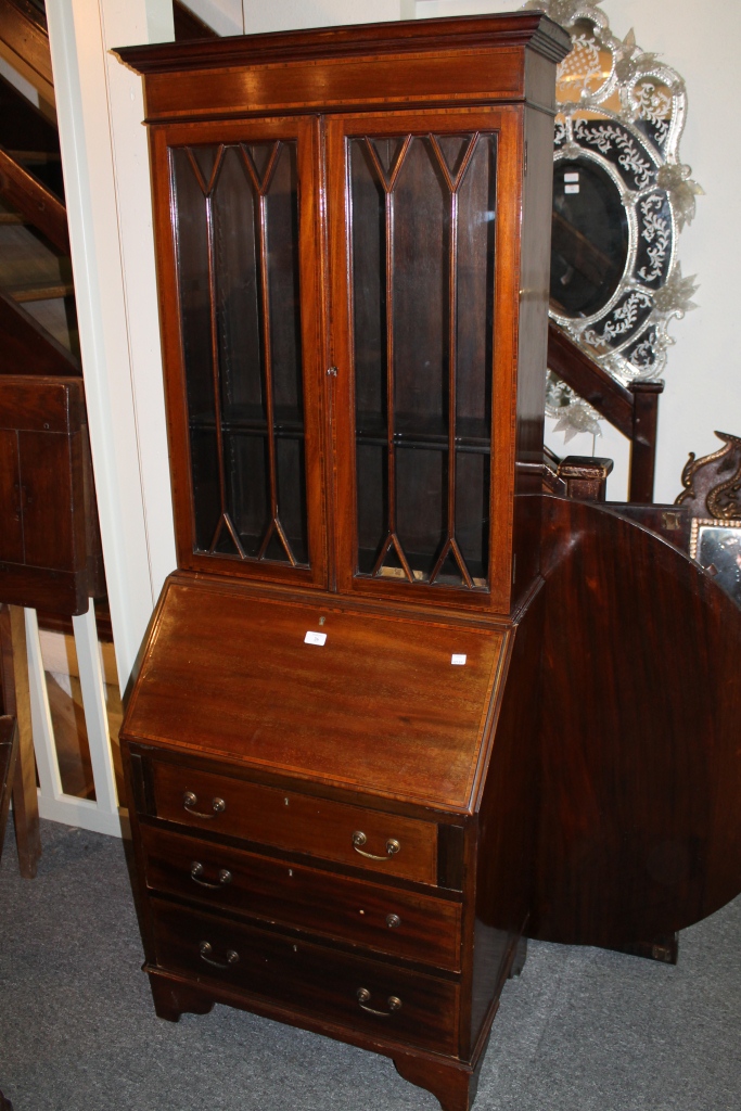 AN EDWARDIAN MAHOGANY BUREAU BOOKCASE, the upper section enclosed by two glazed panel door, lower