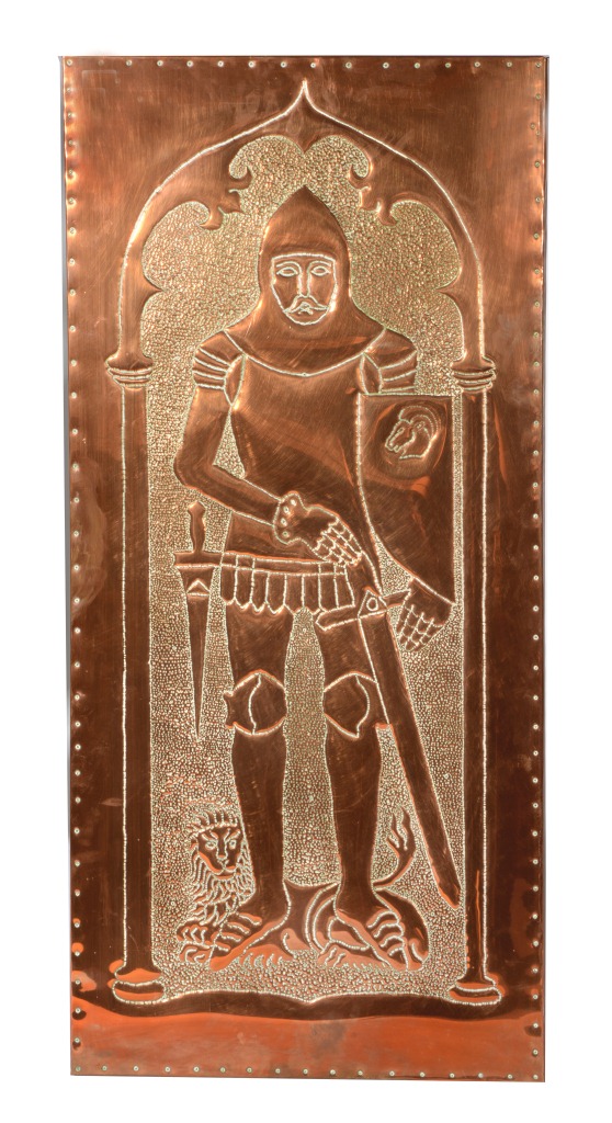 AN EMBOSSED COPPER WALL PLAQUE in the form of a knight taken from a monumental brass, 46" x 21"