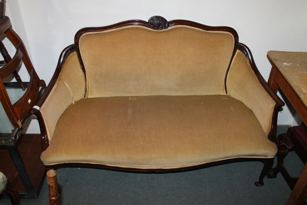 AN EDWARDIAN MAHOGANY FRAME SMALL SOFA with carved shell back, 54" across