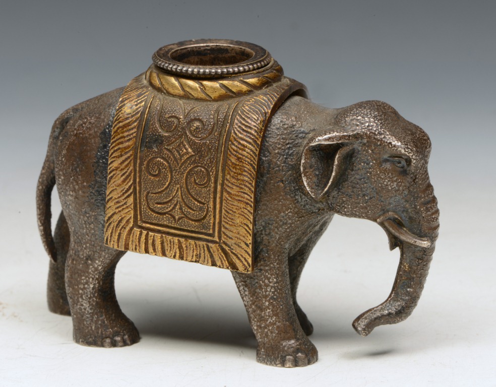 A CAST BRONZE FIGURE OF AN ELEPHANT, the howdah in the form of an inkwell, 2 1/2" high