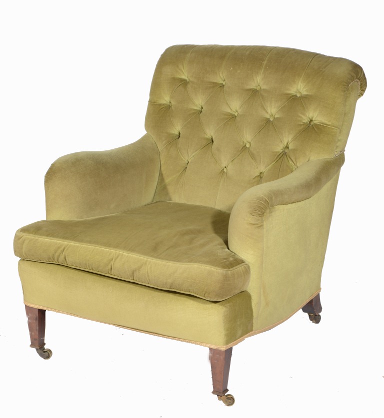 A VICTORIAN BUTTON BACK ARMCHAIR with shaped arms and walnut square taper forelegs with brass