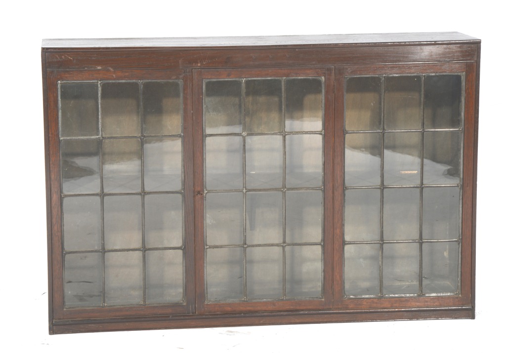 AN OAK DISPLAY CABINET enclosed by leaded panels, 24" high, 36" wide
