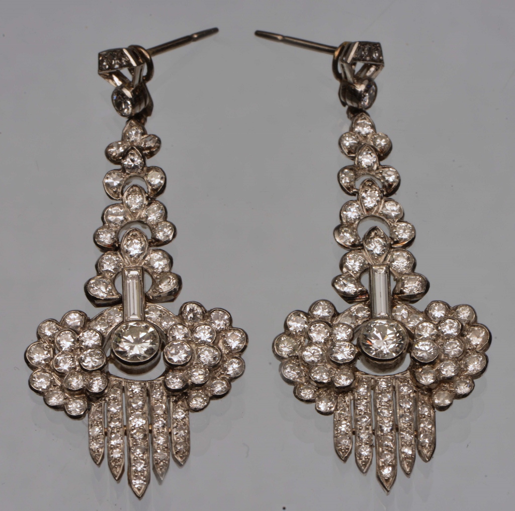 A PAIR OF DIAMOND SET DROP EARRINGS with hinged interlocking diamond set panels with a diamond set