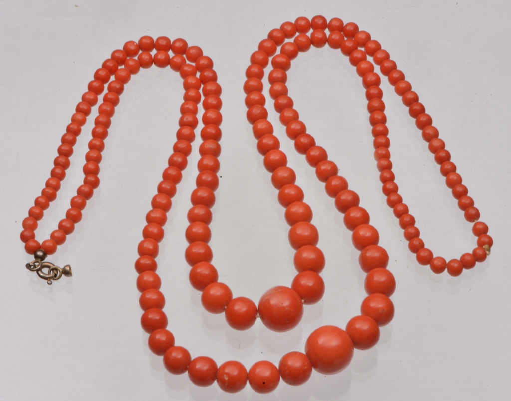 A DOUBLE ROW GRADUATED CORAL BEAD NECKLACE, shortest length 16" beads measuring, 13mm diameter