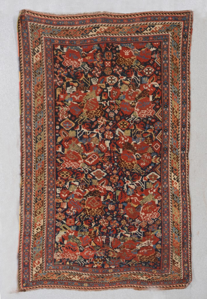 A KHAMESH BLUE GROUND RUG with all over polychrome stylised decoration and multiple border, 1.78m x