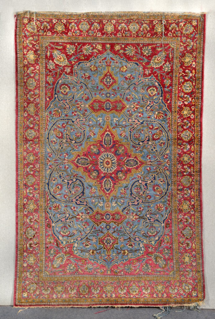 AN ISFAHAN BLUE GROUND SILK RUG decorated a central foliate medallion within a field of scrolling