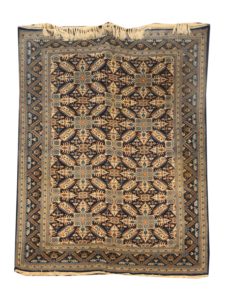 A PAIR OF PERSIAN DARK BLUE GROUND RUGS decorated interlocking stars within a zigzag border,