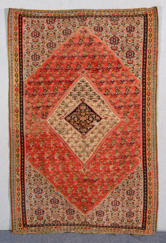 A TURKISH KELIM with central diamond medallion in a red and blue field with triple border, 2.05m x