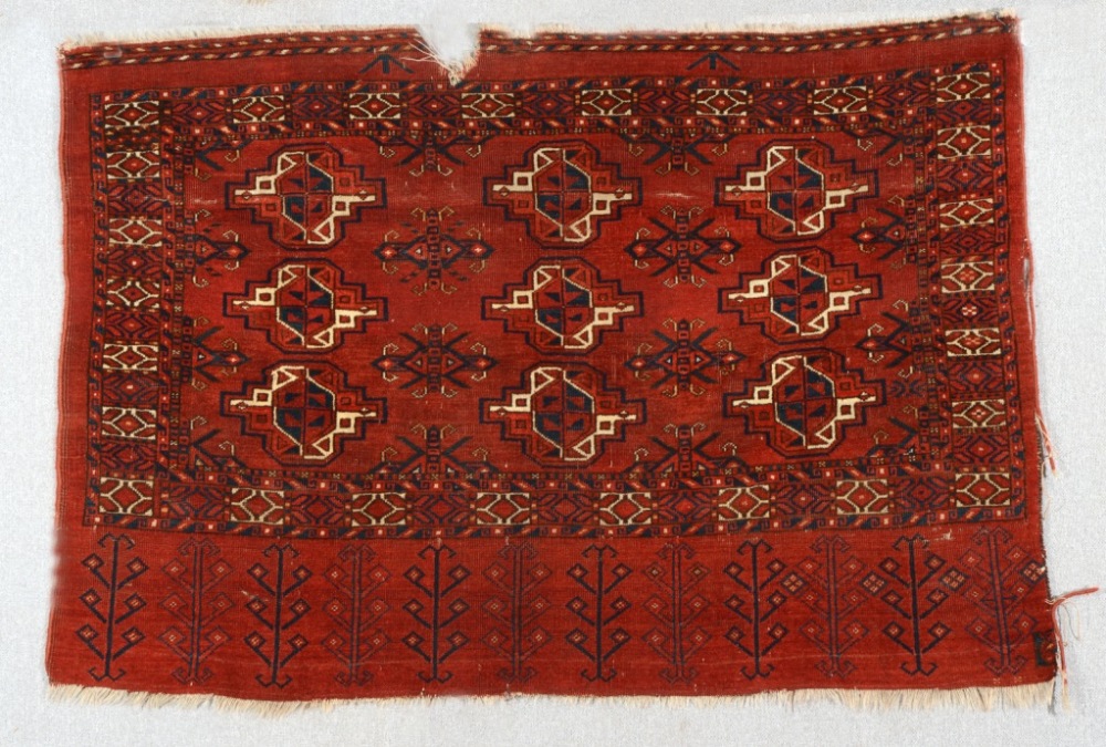 AN ERSARI JUVAL decorated three rows of guls on a deep red field, the skirt with hooked design, 0.