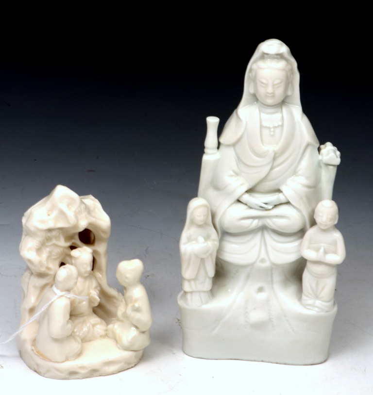 A CHINESE BLANC DE CHINE SMALL MODEL OF THREE SEATED FIGURES set against a bocage, 9.5cm high,