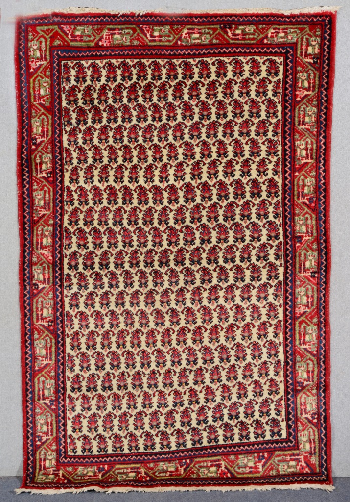 A HAMADAN, SEREBEND WHITE GROUND RUG decorated numerous rows of botehs within a wide border, 2.08m