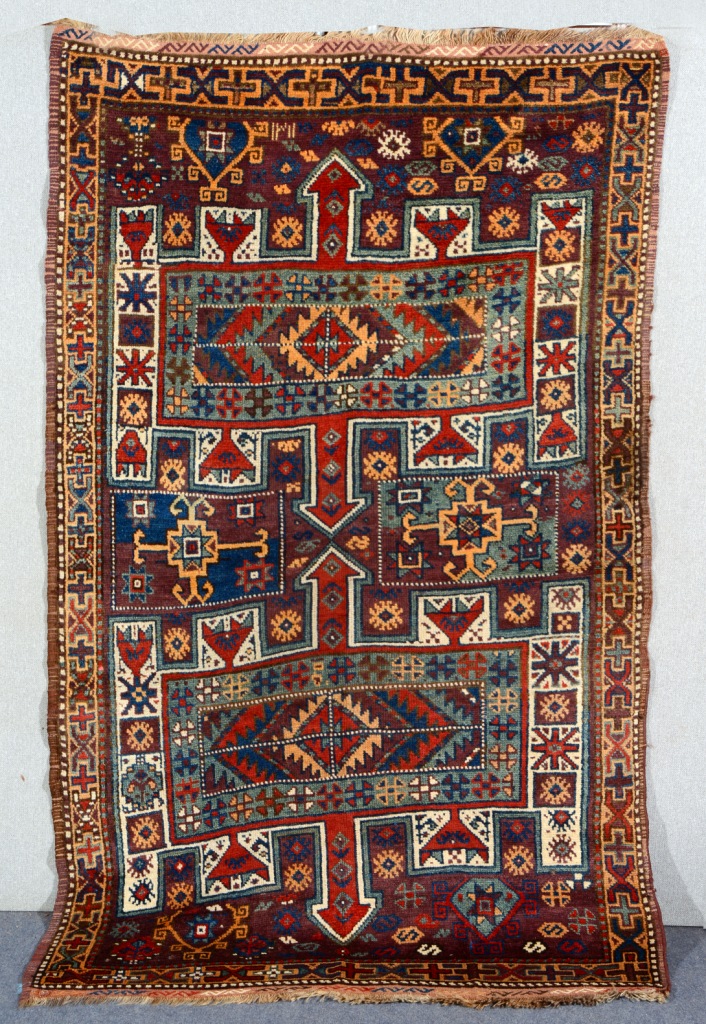 A TURKISH OR KURDISH DATED POLYCHROME RUG with all over stylised geometric decoration and flat