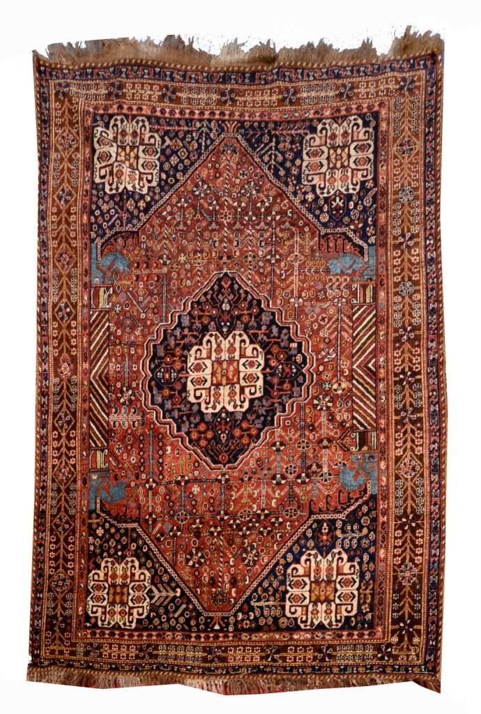 A QASHQAI RUST GROUND RUG with a central blue ground medallion within a field of stylised designs