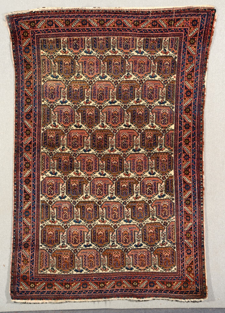 AN AFSHAR WHITE GROUND RUG decorated rows of botehs within a multiple alternating border, 1.93m x