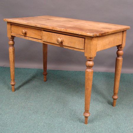 An early 20th century pine side table, containing a pair of short drawers, on turned legs, 106cm