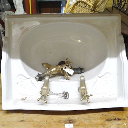 A Sanitan white glazed sink with brass taps, 64cm