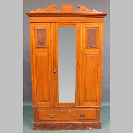 An Edwardian satin walnut wardrobe, with a mirrored door and drawer below, 126cm