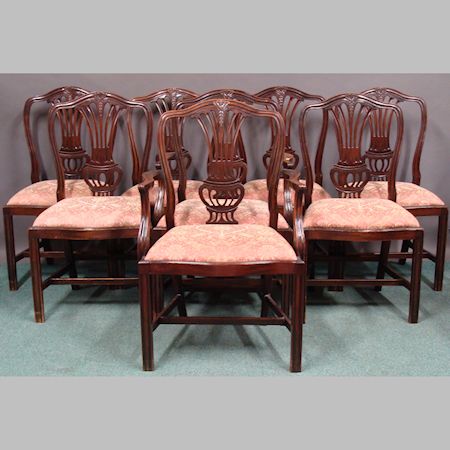 A set of eight Hepplewhite style mahogany dining chairs, each having a pierced splat back above a