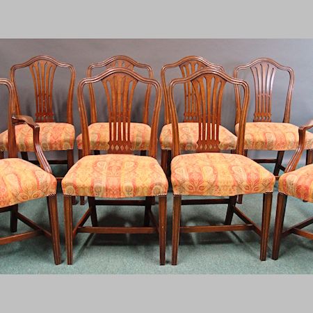 A set of eight George III mahogany red and gold upholstered Chippendale style dining chairs, to