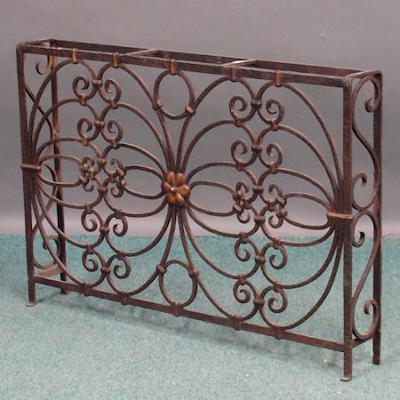 An antique black painted wrought iron fire screen, 79cm