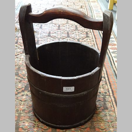 A coopered wooden bucket, with a wooden handle