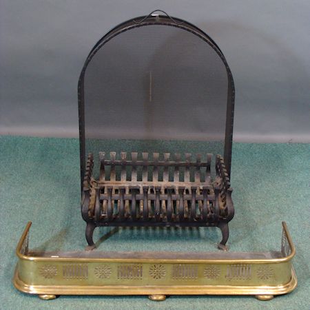 A cast iron fire basket, 50cm, together with an iron fire guard and a pierced brass fender