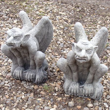 A pair of reconstituted stone gargoyles, 28cm tall