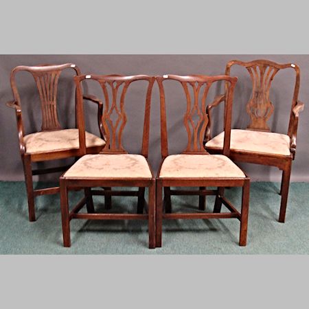 Four George III mahogany dining chairs, of Chippendale style, on square legs
