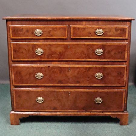 A burr walnut, feather strung and crossbanded chest, containing two short over three long