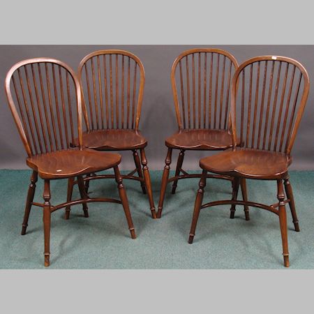 A set of four spindle back dining chairs, stamped Stewart Linford, together with a pair similar