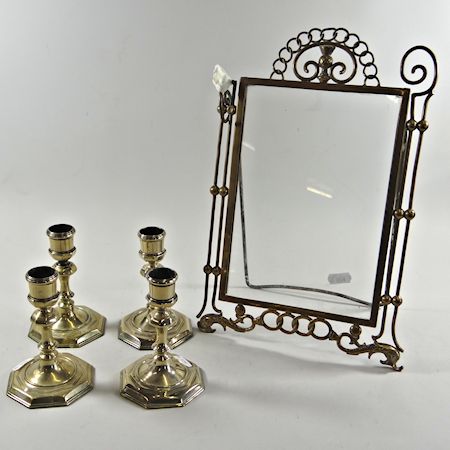 Four brass candlesticks, together with a brass frame