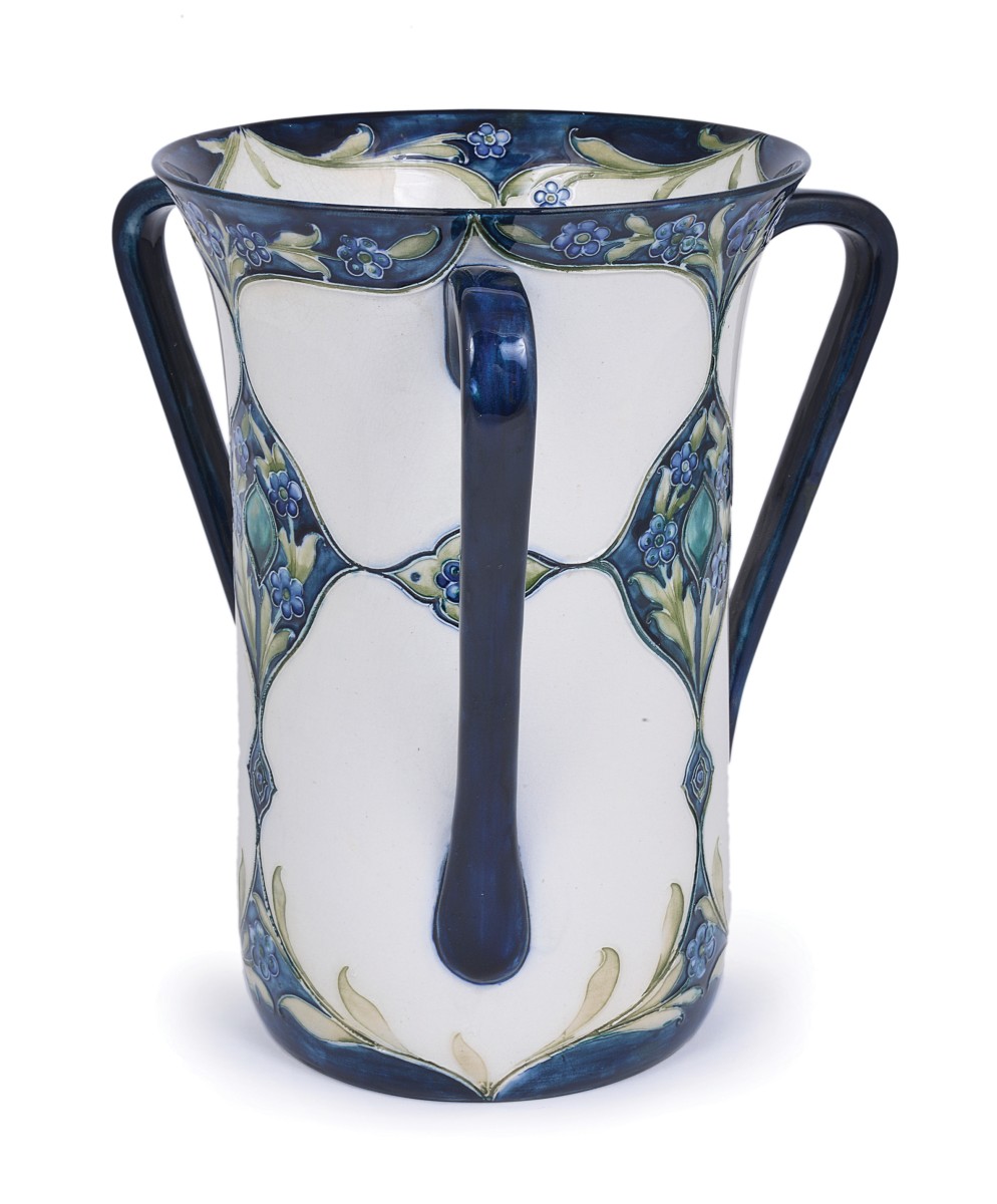 FORGET-ME-NOTS: A TALL MOORCROFT MACINTYRE THREE-HANDLED VASE, CIRCA 1909 decorated with stylised