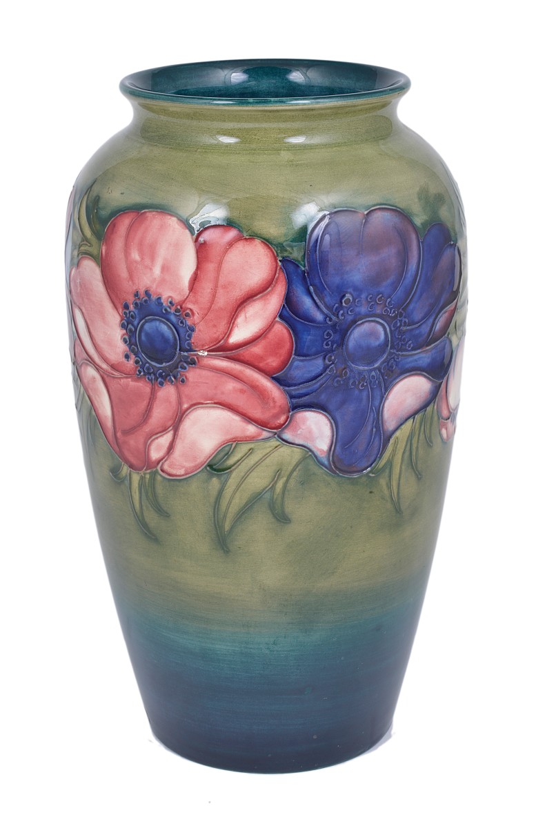 ANEMONE: A MOORCROFT SLENDER OVOID VASE, CIRCA 1950 tube lined with purple and mauve flowers against