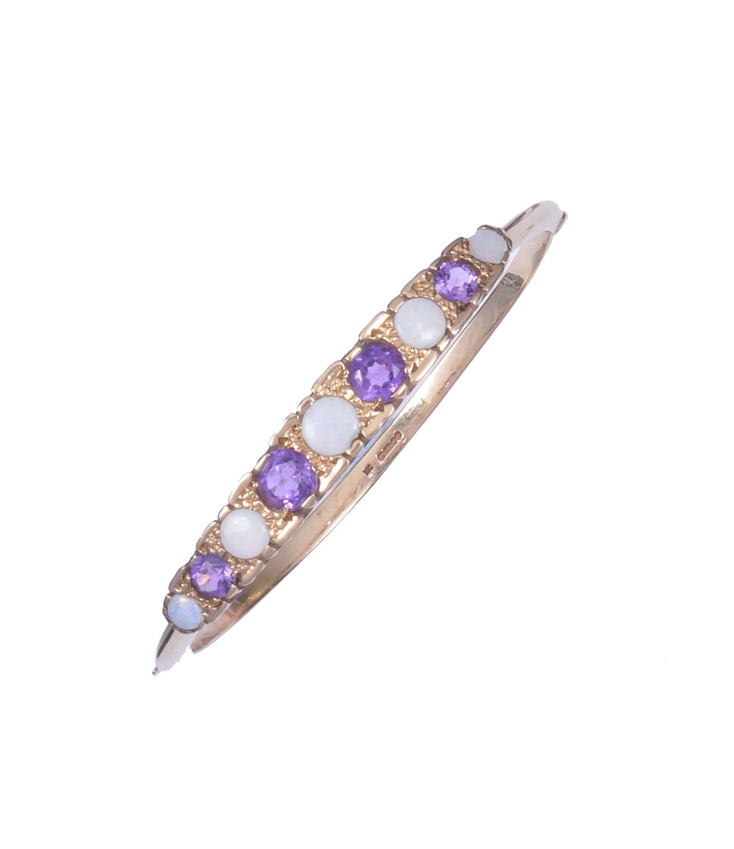 AMETHYST AND OPAL BANGLE, set to the front with a row of alternating circular-cut amethyst and