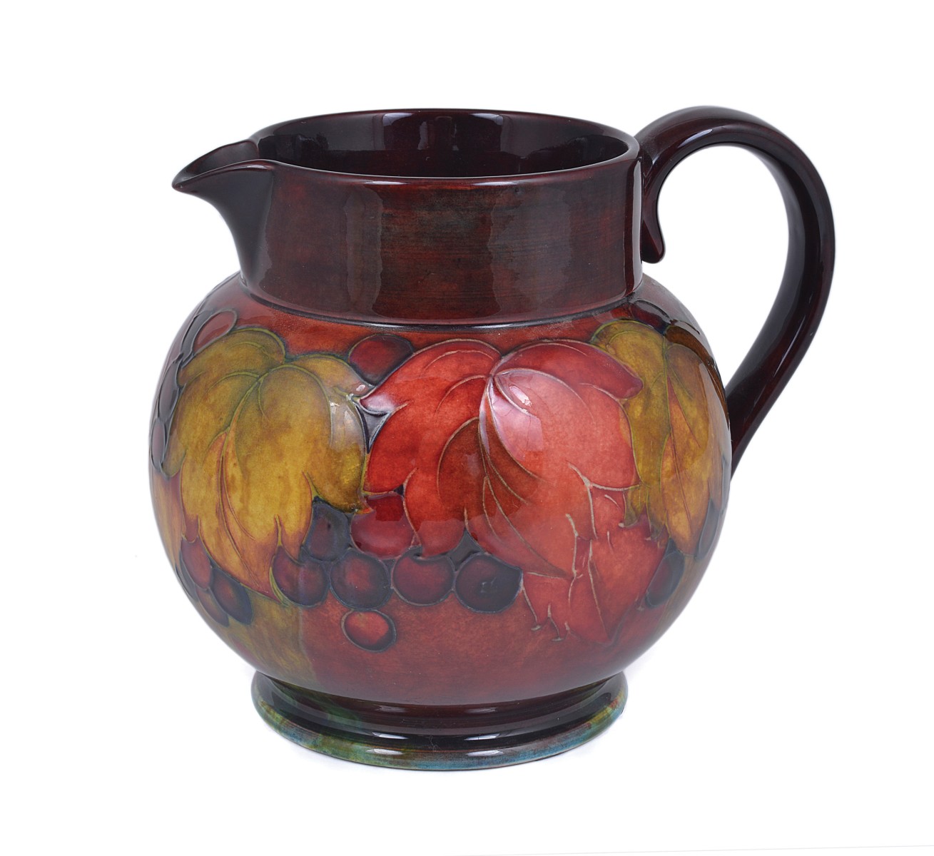 LEAF AND BERRY: A MOORCROFT FLAMBÉ JUG, CIRCA 1930 with tube lined bulbous body, impressed MOORCROFT