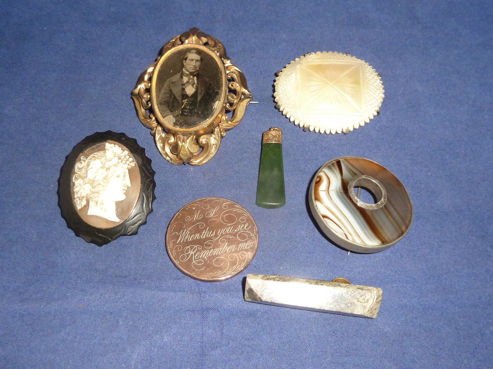 An ornate gilt Victorian brooch with portrait photograph on glass; other Victorian brooches