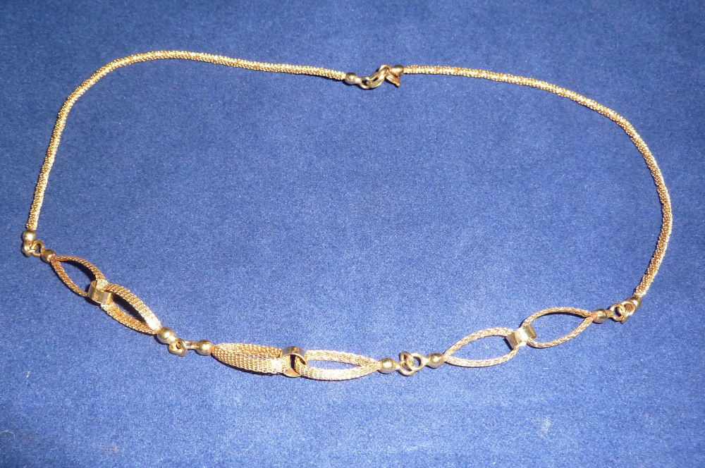 A modern woven yellow metal necklace, stamped `750`
