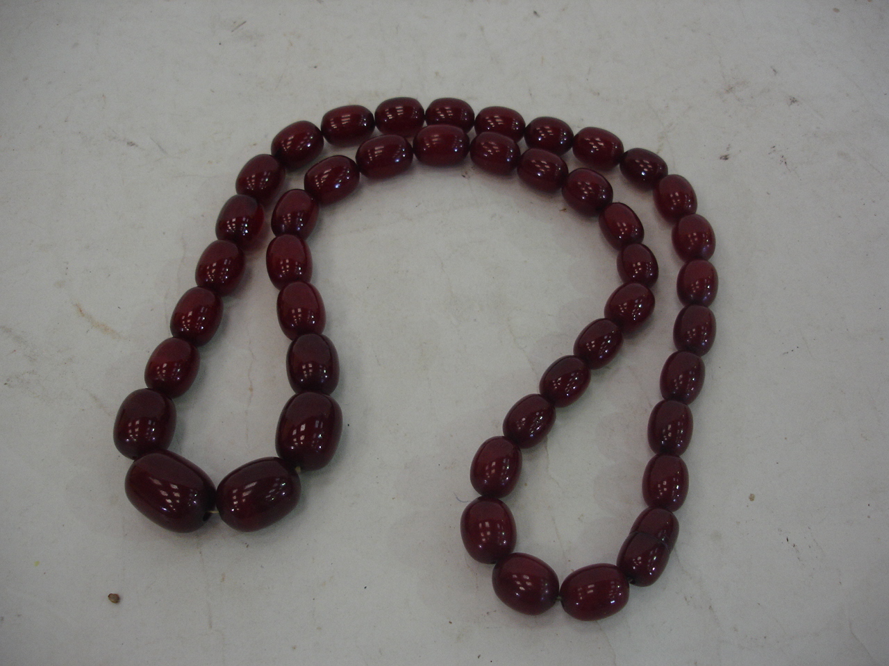 A cherry amber bead necklace 30" long