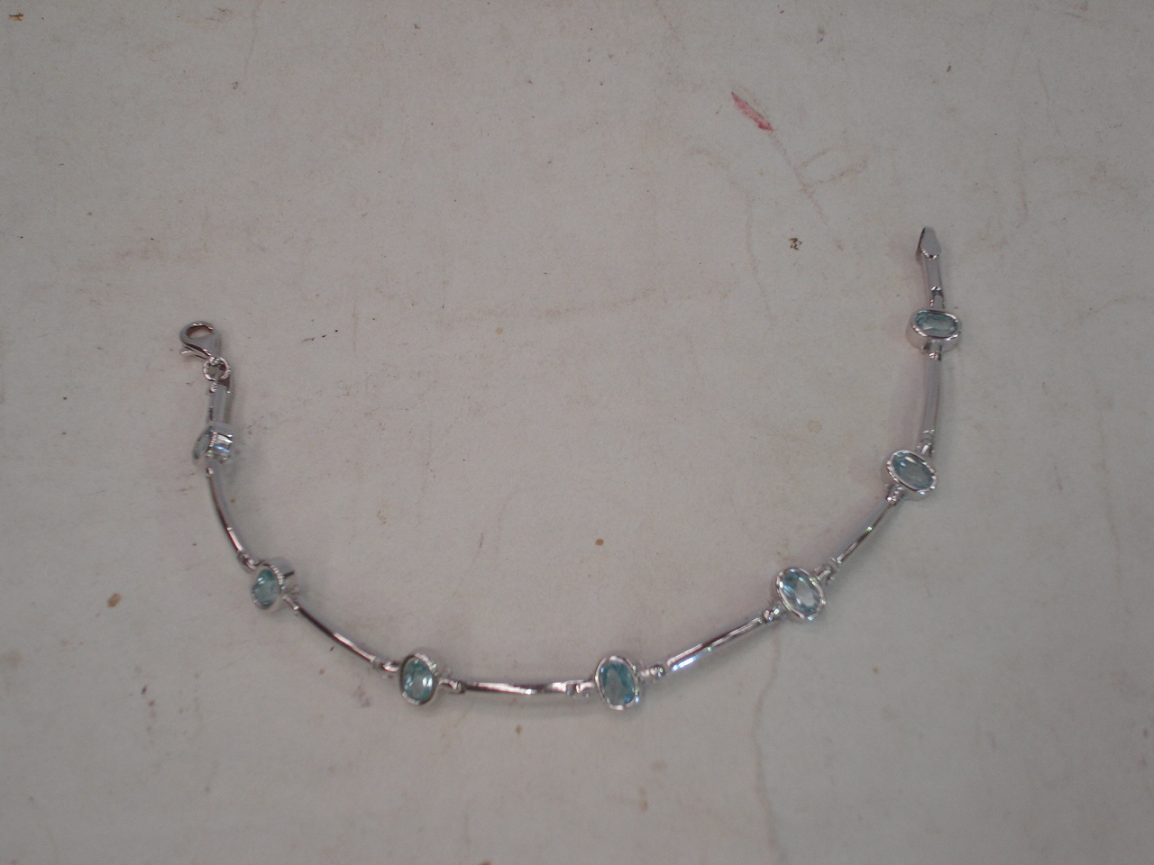 A 9ct white gold and light blue stone bracelet