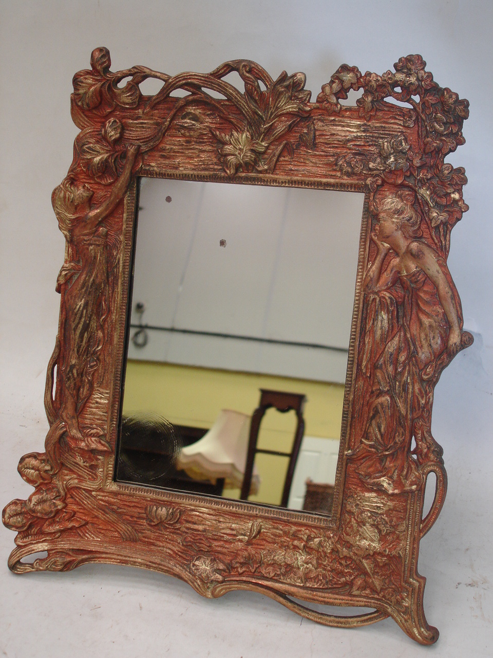 An Art-Nouveau style cast metal easel mirror. Bears registration mark 14" high