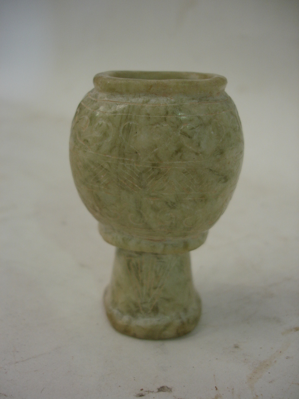 A Chinese carved white / green jade stem pot with scratch decoration. 2 ½" high