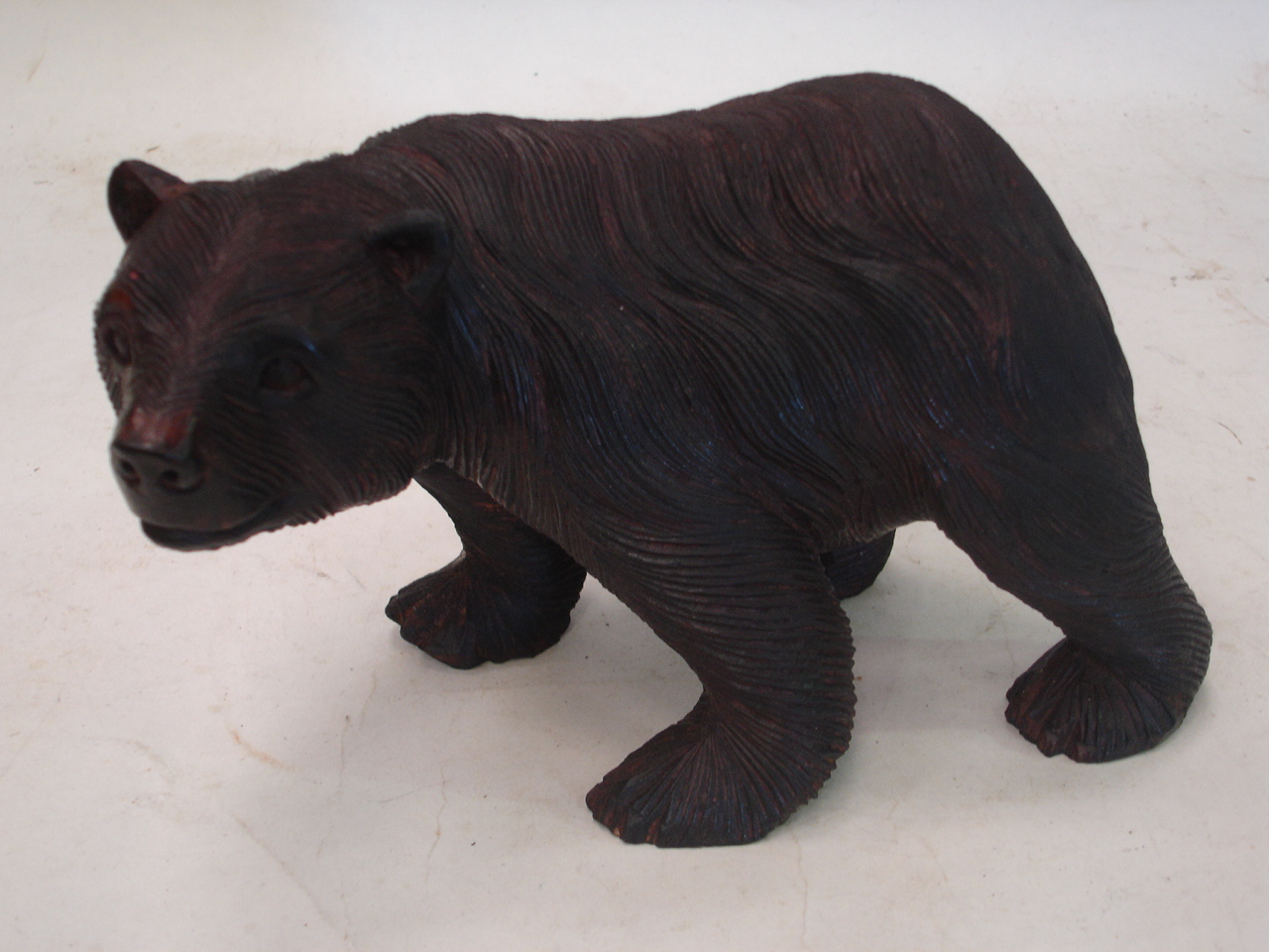 A carved wood bear, 9 ½" long